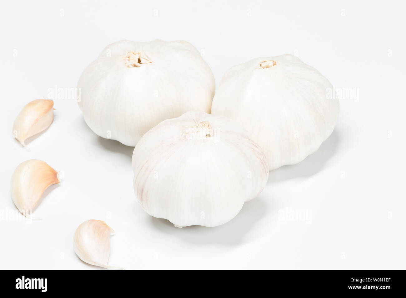 Knoblauch und komplette Knoblauch gegen einen weißen Hintergrund Stockfoto