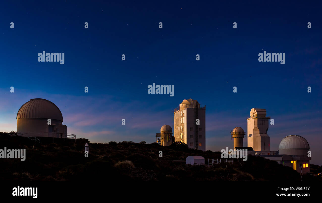 Teleskope in einer professionellen astronomischen Sternwarte bei Sonnenuntergang mit der sichtbaren Sterne im Himmel Stockfoto