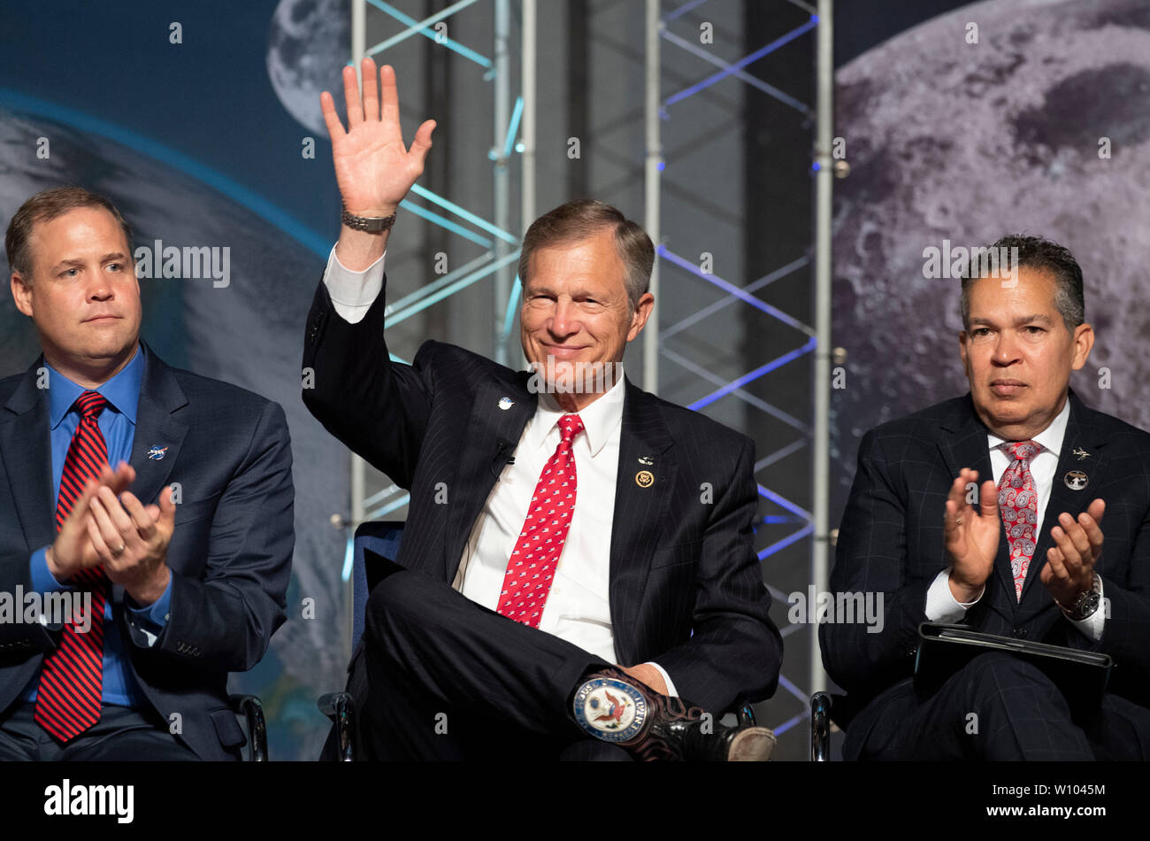 Abgeordneter Dr. Brian Babin von Texas Wellen als Würdenträger außerhalb Houston sammeln die restaurierte Mission Control Center zu Ehren des 50. Jahrestags der Mondlandung Apollo 11 von 1969 zu widmen. Auf der linken Seite ist die NASA Administrator Jim Bridenstine; auf der rechten Seite ist Space Center Houston CEO William Harris. Stockfoto