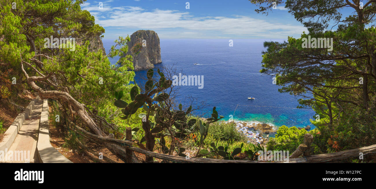 Panoramablick auf die berühmten Faraglioni Felsen, meistbesuchten Attraktion der Insel Capri, Italien. Schönes Paradies Landschaft mit azurblauen Meer in Summe Stockfoto