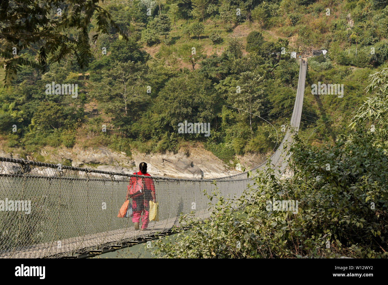 Suspension Fußgängerbrücke aus Narayanghat-Mugling Autobahn auf der südlichen Seite von Seti Gandaki River in der Nähe des Vorsitzes Resort, Chitwan Bezirk, Nepal Stockfoto