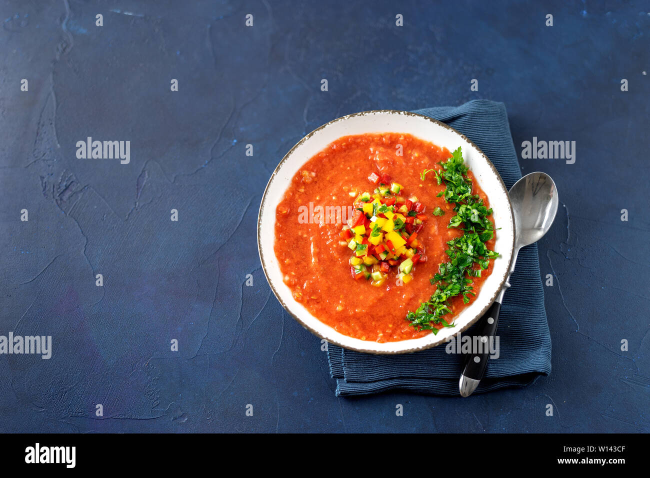 Blick von oben auf die Gazpacho Sommer Suppe in weiße Platte auf blauem Hintergrund Stockfoto