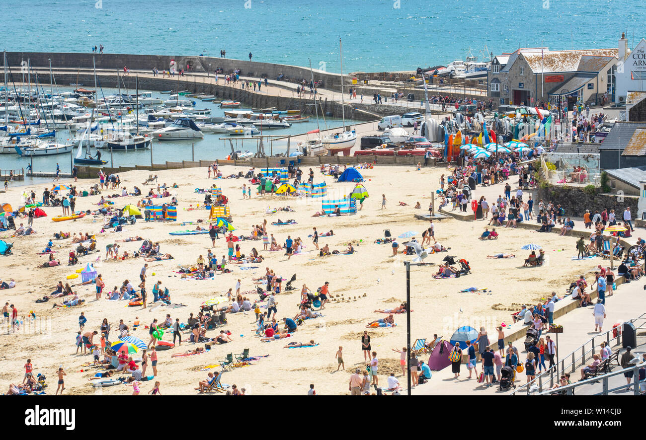 Lyme Regis, Dorset, Großbritannien. 30. Juni 2019. UK Wetter: warm, sonnig und eine erfrischende Brise in den Badeort Lyme Regis. Besucher am Sandstrand entspannen Sie am Sonntag Nachmittag, als die Hitzewelle im Juni fort. Credit: Celia McMahon/Alamy leben Nachrichten Stockfoto