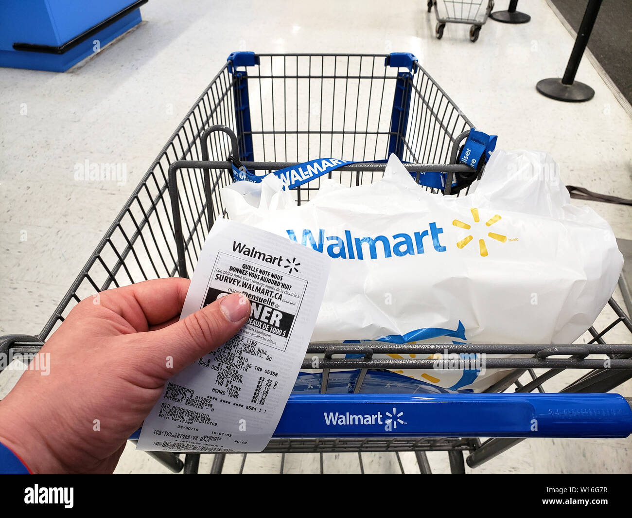 MONTREAL, KANADA - 30. APRIL 2019: Walmart Warenkorb mit Tasche und Empfang im Walmart Stores. Walmart ist eine US-amerikanische Einzelhandel Corporation, Stockfoto