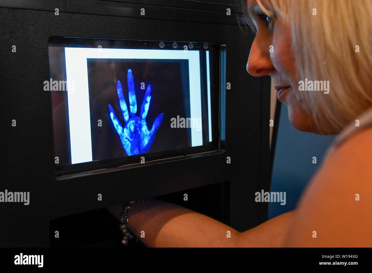 London, Großbritannien. 1. Juli 2019. Auf der Universität von Nottingham, eine Frau sieht die Oberfläche von ihrer Hand unter UV-Licht enthüllt die Bakterien auf dem Palm. Vorschau der jährliche Sommer Wissenschaft Ausstellung in der Royal Society. 22. weist einige der neuesten und innovativsten Forschung in Wissenschaft, Ingenieurwesen und Technologie Übersicht über von Großbritannien ist für die Öffentlichkeit vom 1. Juli bis zum 7. Juli 2019 präsentiert. Credit: Stephen Chung/Alamy leben Nachrichten Stockfoto