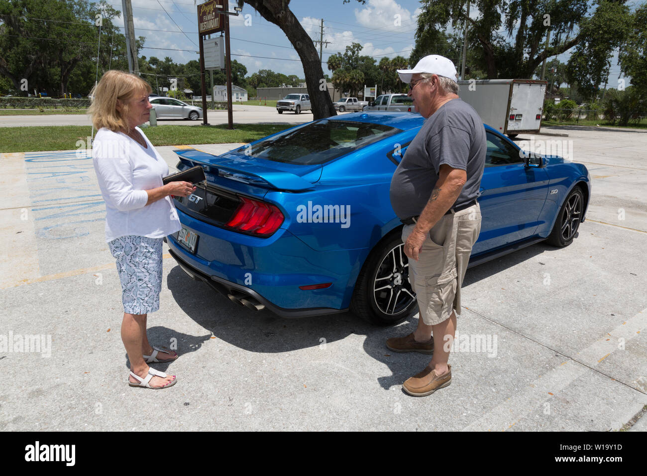 Eine Frau zeigt ihre neue Blue 2019 Ford Mustang GT in Okeechobee, Florida, USA. Stockfoto