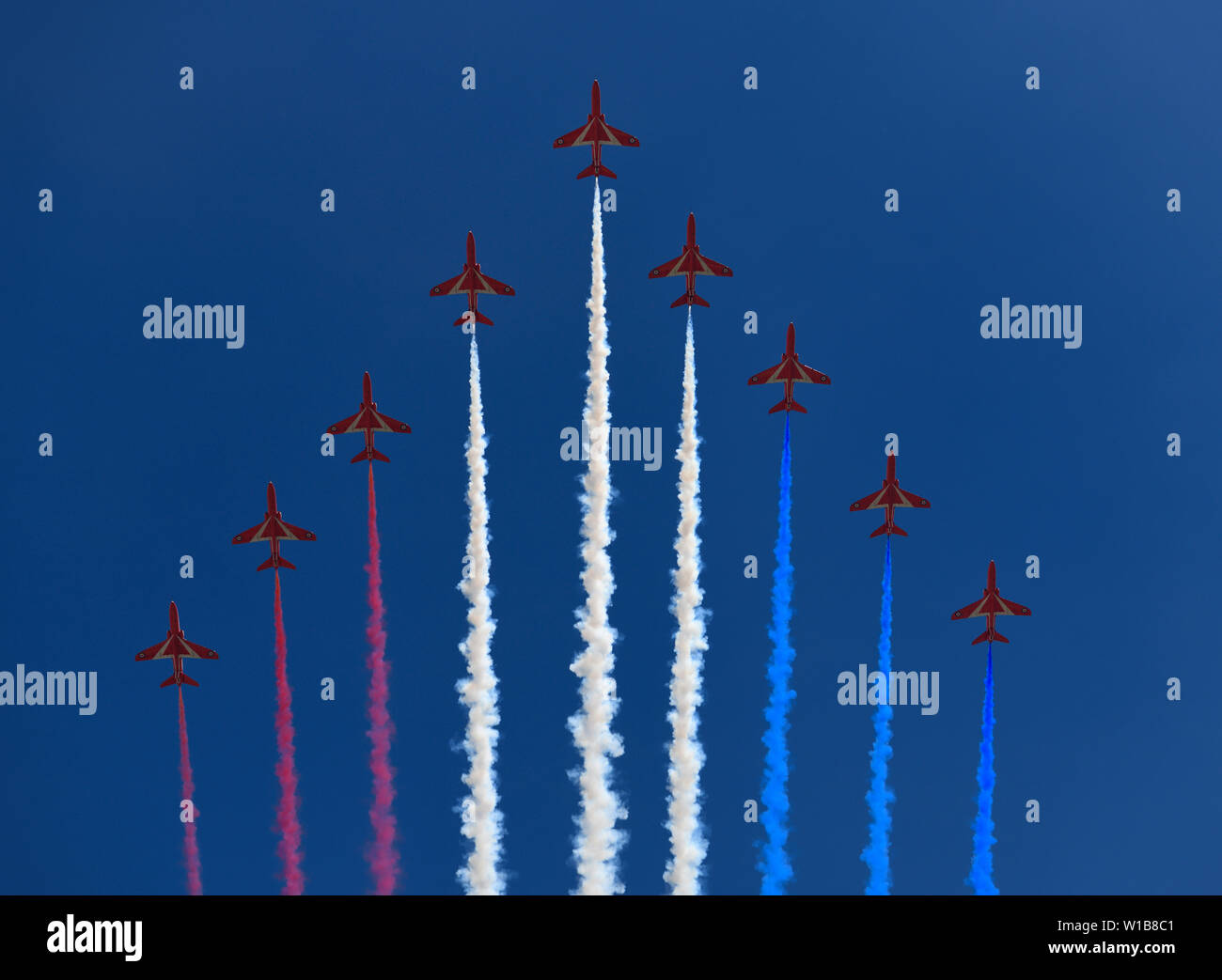 Bildung von RAF Red Arrows mit farbigen Spuren auf blauen Himmel für Flypast auf die Farbe für Queen Elizabeth's 93. Geburtstag London England Stockfoto
