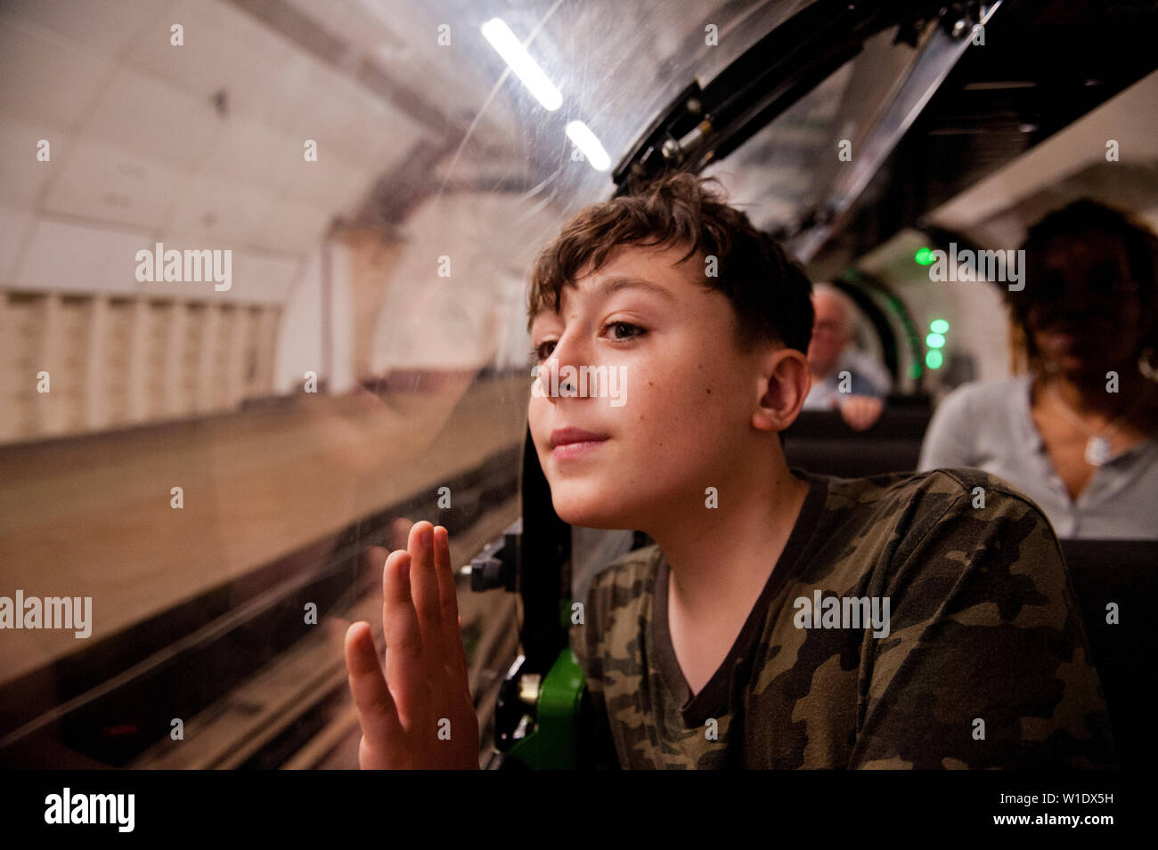 Teenager reiten auf dem Mail Rail Zug am Postal Museum, London, Stockfoto