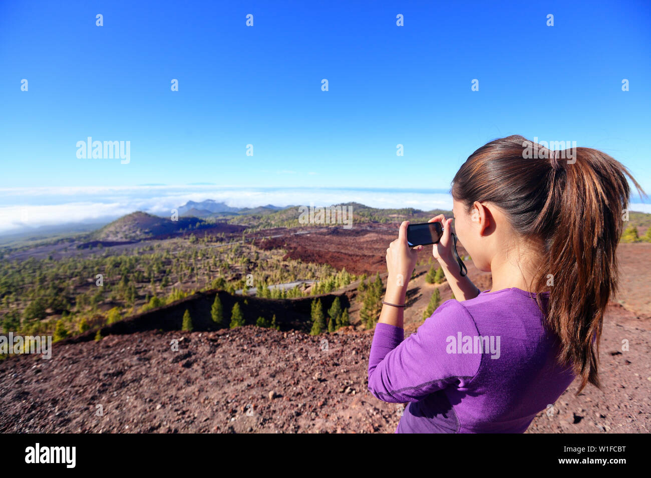 Wanderer Landschaft Bild oben am Berg. Schöne Natur auf dem Vulkan Teide, Teneriffa, Kanarische Inseln mit Mädchen Tourist können Sie über Smartphone, Fotos zu machen. Stockfoto