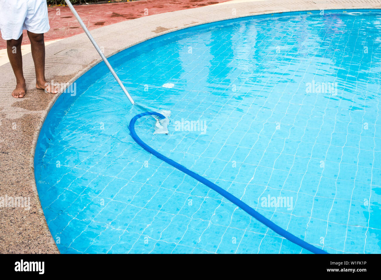Mann Reinigung ein Schwimmbad im Sommer. Sauberer Pool. Stockfoto