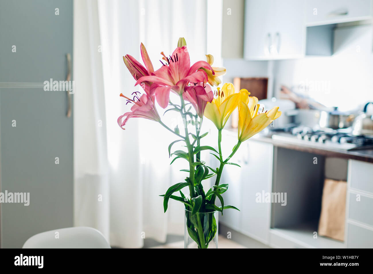 Bunte Lilien. Moderne Küche Design. Innenraum weiss und silber Küche mit Strauß mit frischen Blumen geschmückt. Stockfoto