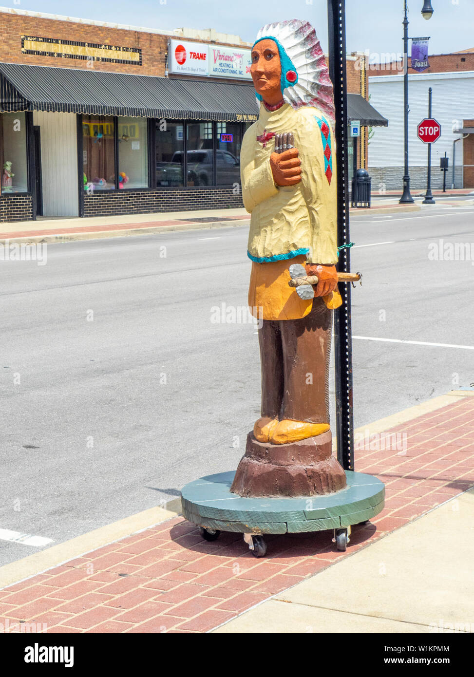 Geschnitzte hölzerne Indianer Mann hält gigars auf Hauptstraße Collinsville Illinois USA. Stockfoto