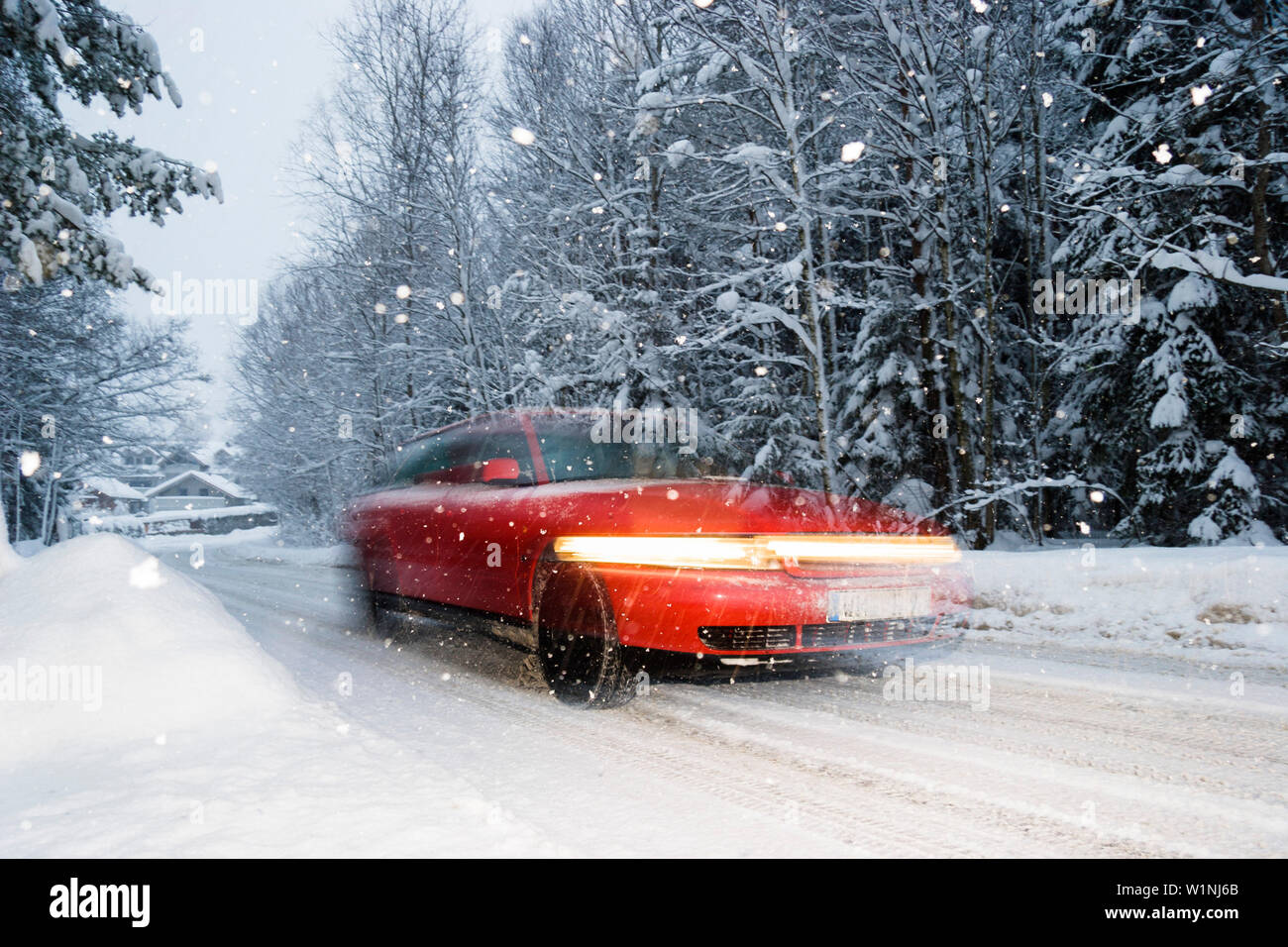 Auto bei Schneegestöber, Straßenverkehr im Winter, Bayern, Deutschland Stockfoto