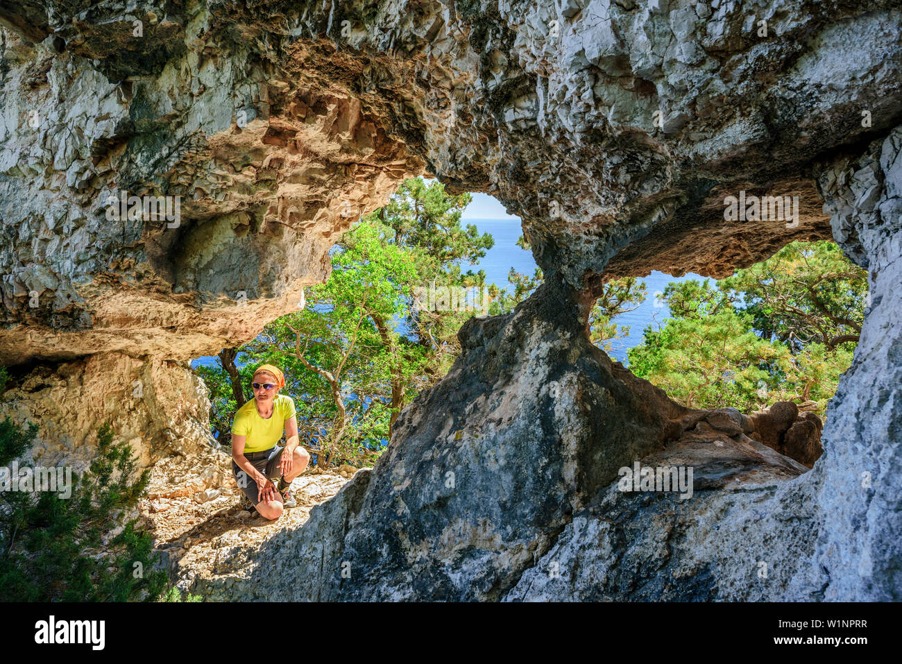 Frau sitzt an Bogen, Selvaggio Blu, National Park in der Bucht von Orosei und Gennargentu, Sardinien, Italien Stockfoto