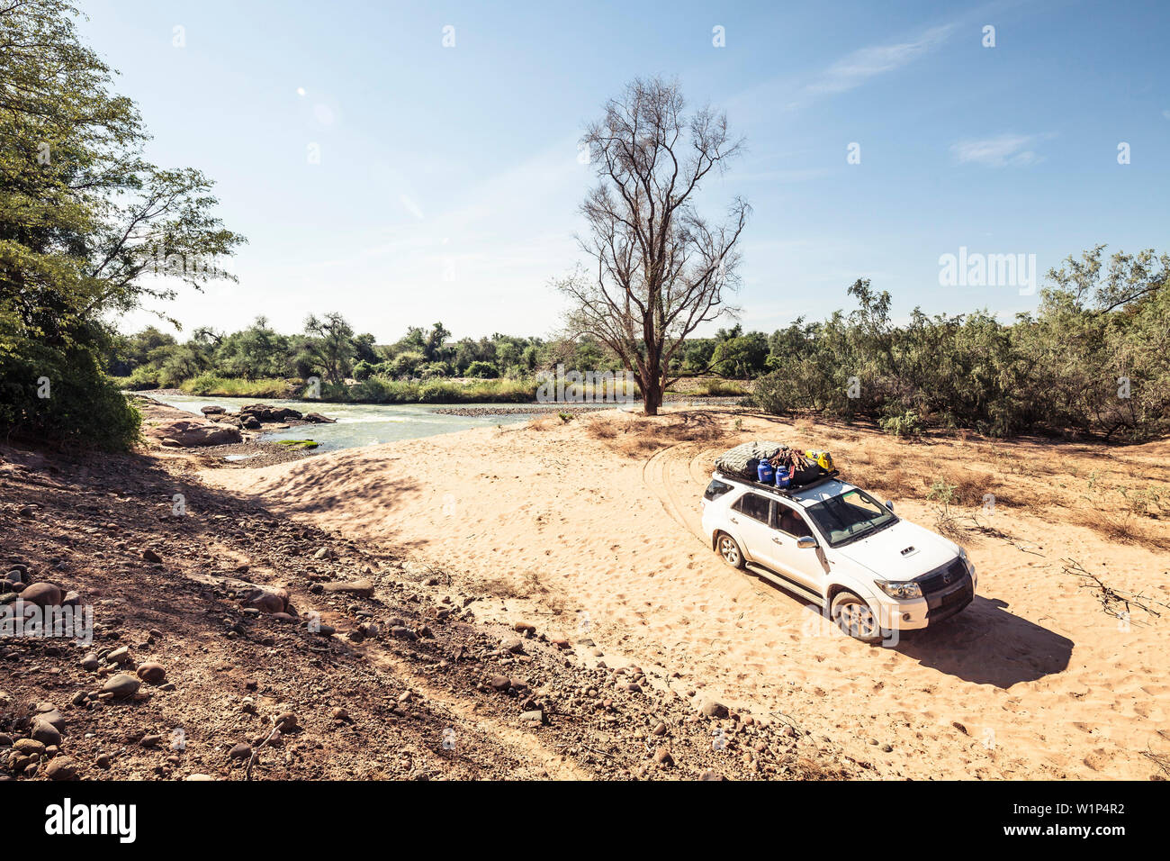 All-terrain vehicle Verlassen ein wildes camping Platz am Kunene Fluss, der die natürliche Grenze zu Angola. Namibia, Afrika Stockfoto