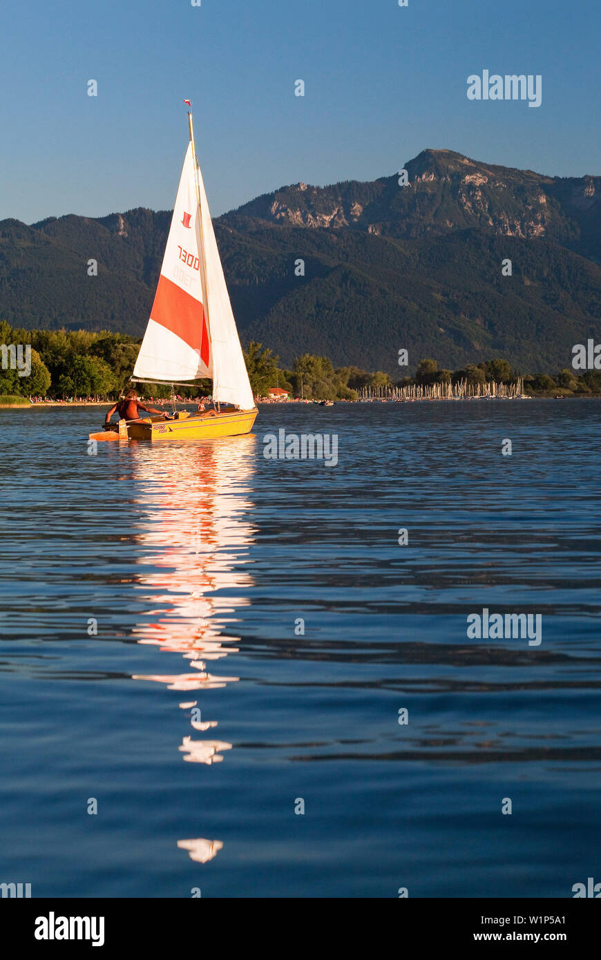 Kleines Segelboot in das Feld Wieser Bucht vor dem Strand, Hafen und die mächtigen Hochfelln Segler im Hintergrund Stockfoto
