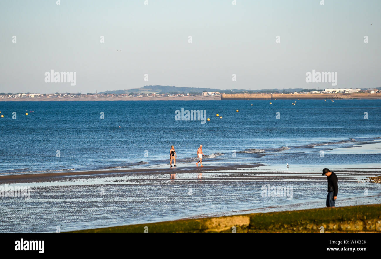 Brighton UK 4. Juli 2019 - Schwimmer am frühen Morgen einen Dip aus Brighton und Hove Strand genießen. Das Wetter wird prognostiziert einen weiteren sonnigen Tag an der Südküste von Großbritannien mit zu erwartenden Höchsttemperaturen um 27 Grad in einigen Teilen zu erreichen. Foto: Simon Dack/Alamy leben Nachrichten Stockfoto