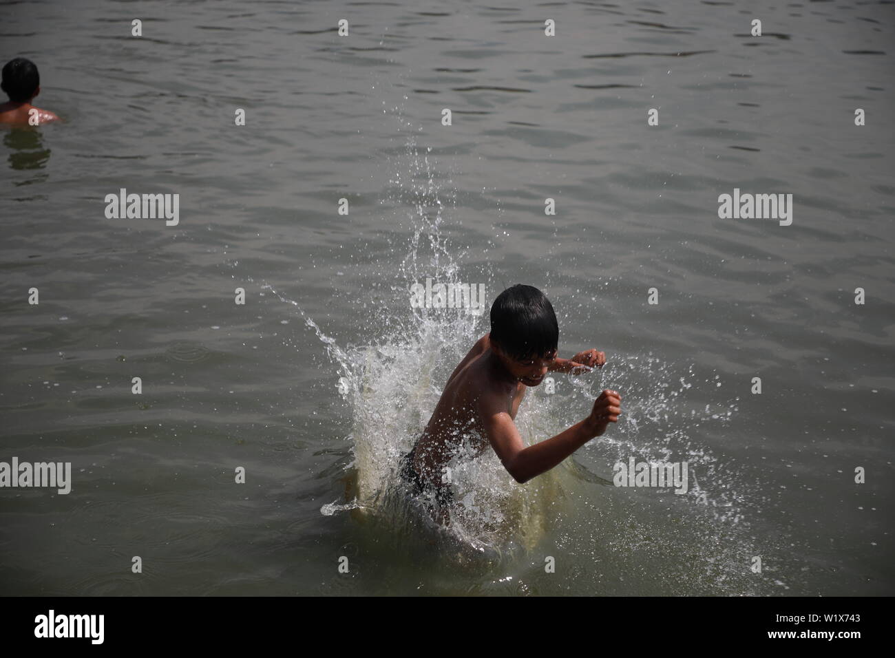 Kathmandu, Nepal, 29. Juni 2019. Die hohe Temperatur im Kathmandu Tal, Jungen gegen die Hitze schwimmend auf einem Teich in Bhaktapur, Nepa. Sarita Khadka Stockfoto