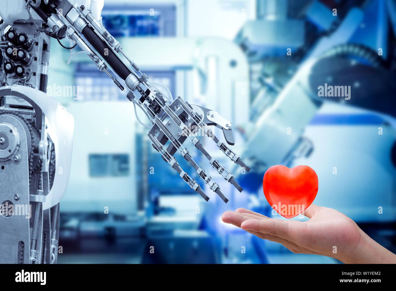 Menschliche Herz auf der Hand an einen Roboter für die Roboter haben Gefühle, Liebe, wie ein Mensch, auf blauen Ton farbe maschine verschwommenen Hintergrund. Stockfoto