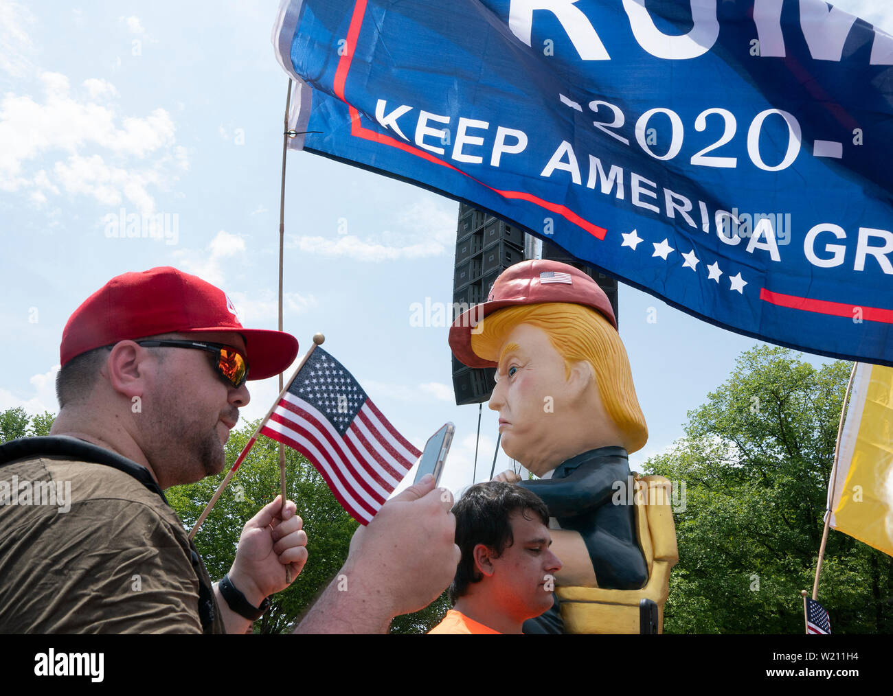 Christopher Casey, in Brooklyn, New York, ausgetauschte Worte mit Leuten, die sich als "Baby Trumpf "Blimp und der Trump Tweeting Statue in Washington, DC am 4. Juli 2019 zu sehen. Credit: Stefani Reynolds/CNP/MediaPunch Stockfoto