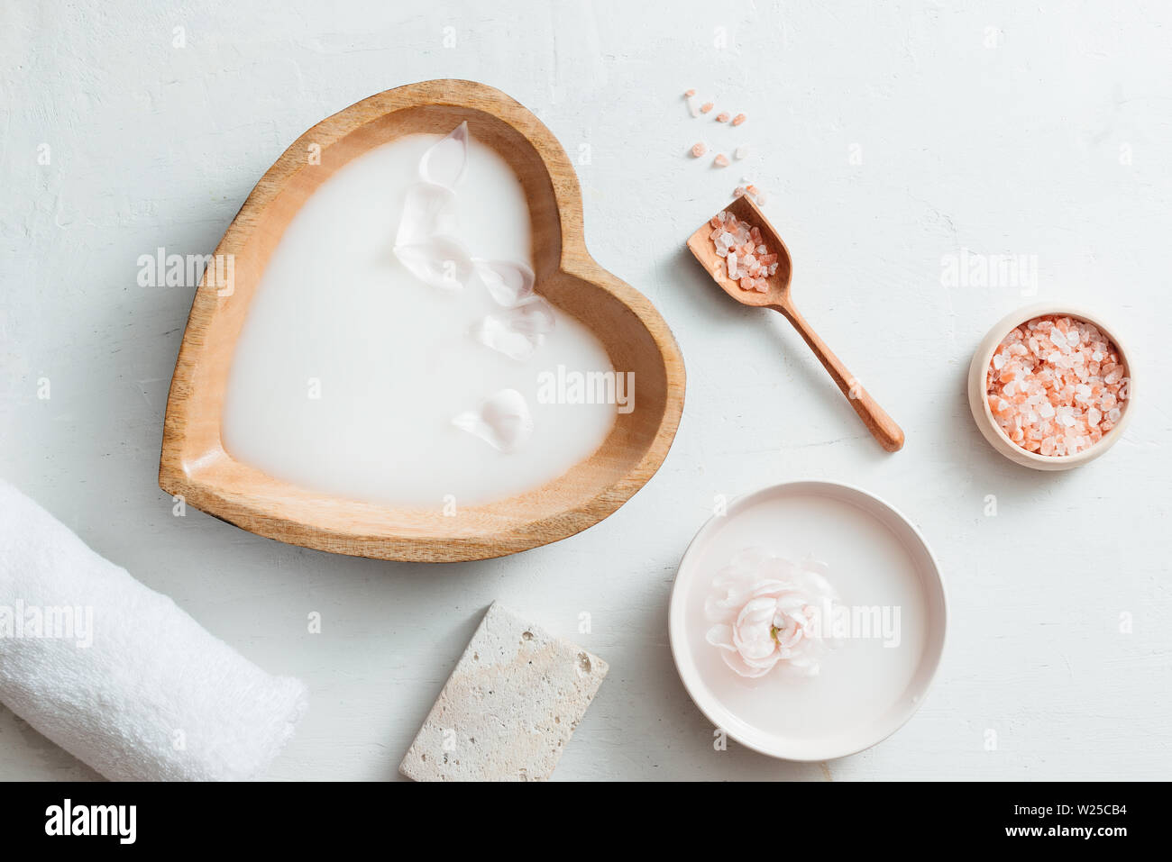 Spa mit Reismilch Schüssel, Blumen, Salz, Seife und Handtuch auf weißem Hintergrund Stockfoto
