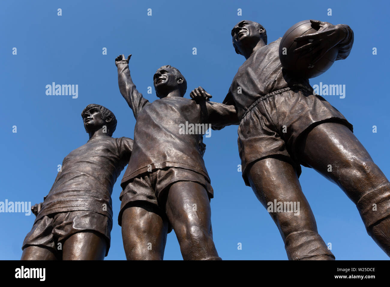 "Die Vereinigten Trinity" - eine Skulptur außerhalb von Old Trafford von Manchester United Football Stadium, mit George Best und Denis Law und Sir Bobby Charlton Stockfoto