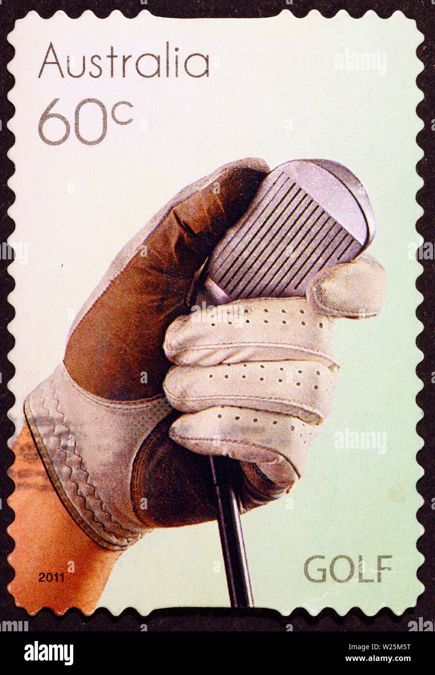 Golf Club und der Hand des Spielers auf Briefmarke Stockfoto