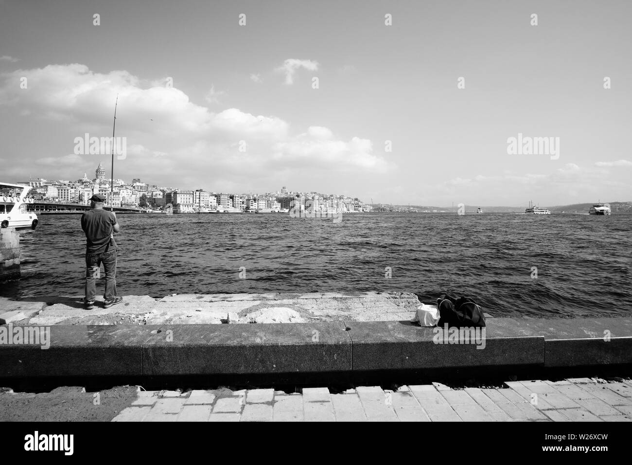 Istanbul, Türkei - 21. September 2017: Fischer auf dem Kai, mit dem berühmten Galata Tower in der Ferne Stockfoto