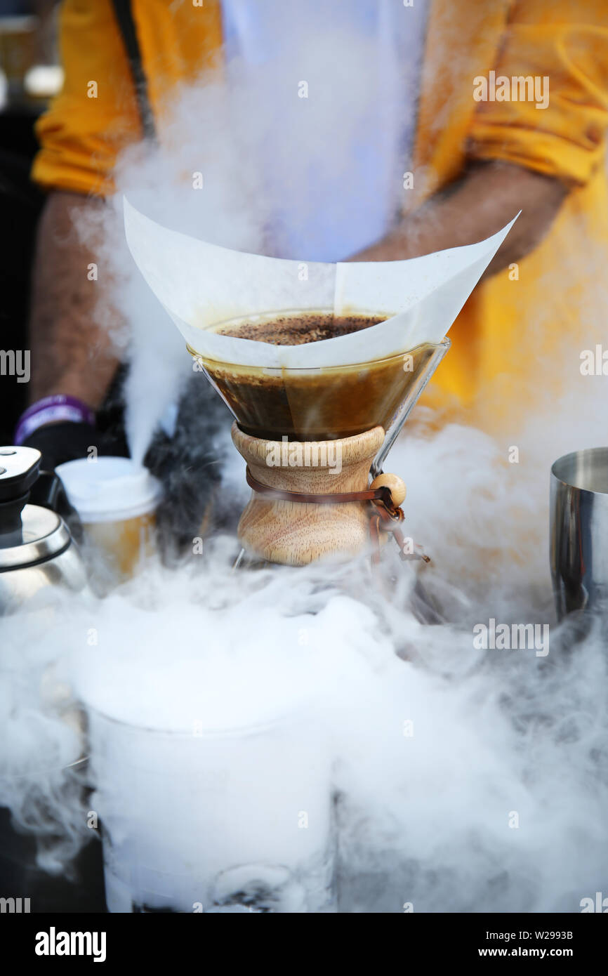 Blühende Kaffee in Papierfilter. Kaffee blühen in den Papierfilter. Kaffee mit einem chemex. Über dritte Welle Kaffee Gießen. Stockfoto