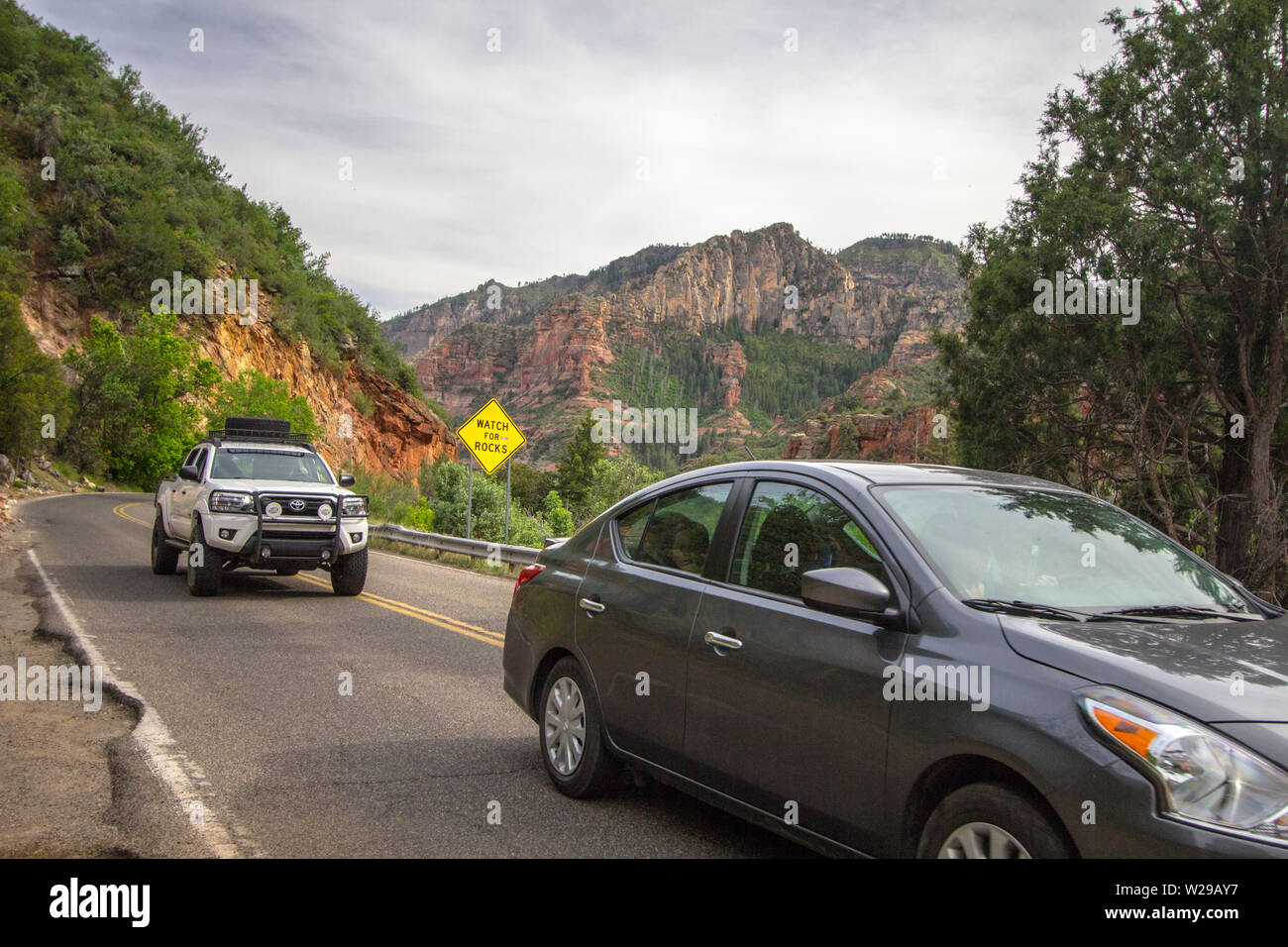Sedona, Arizona, USA - 5. Mai 2019: Autos bewegen sich, um Schlaglöcher und Fußgänger auf den engen gewundenen Bergstraßen von Sedona, Arizona, mit einer Uhr zu vermeiden Stockfoto