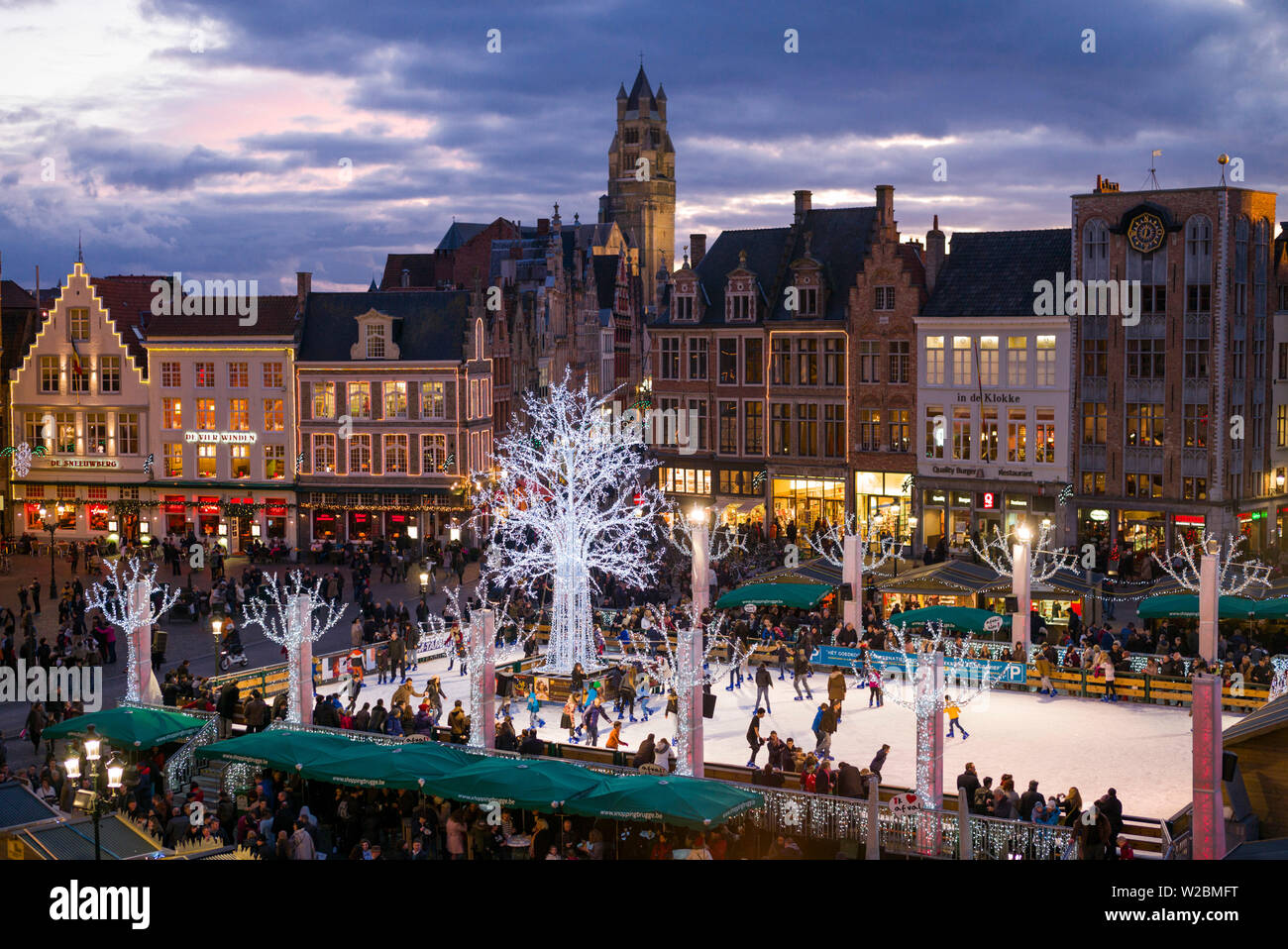 Belgien, Brügge, der Markt, erhöhten Blick auf quadratischen Hauptgebäuden und Winter Eislaufbahn, Dämmerung Stockfoto