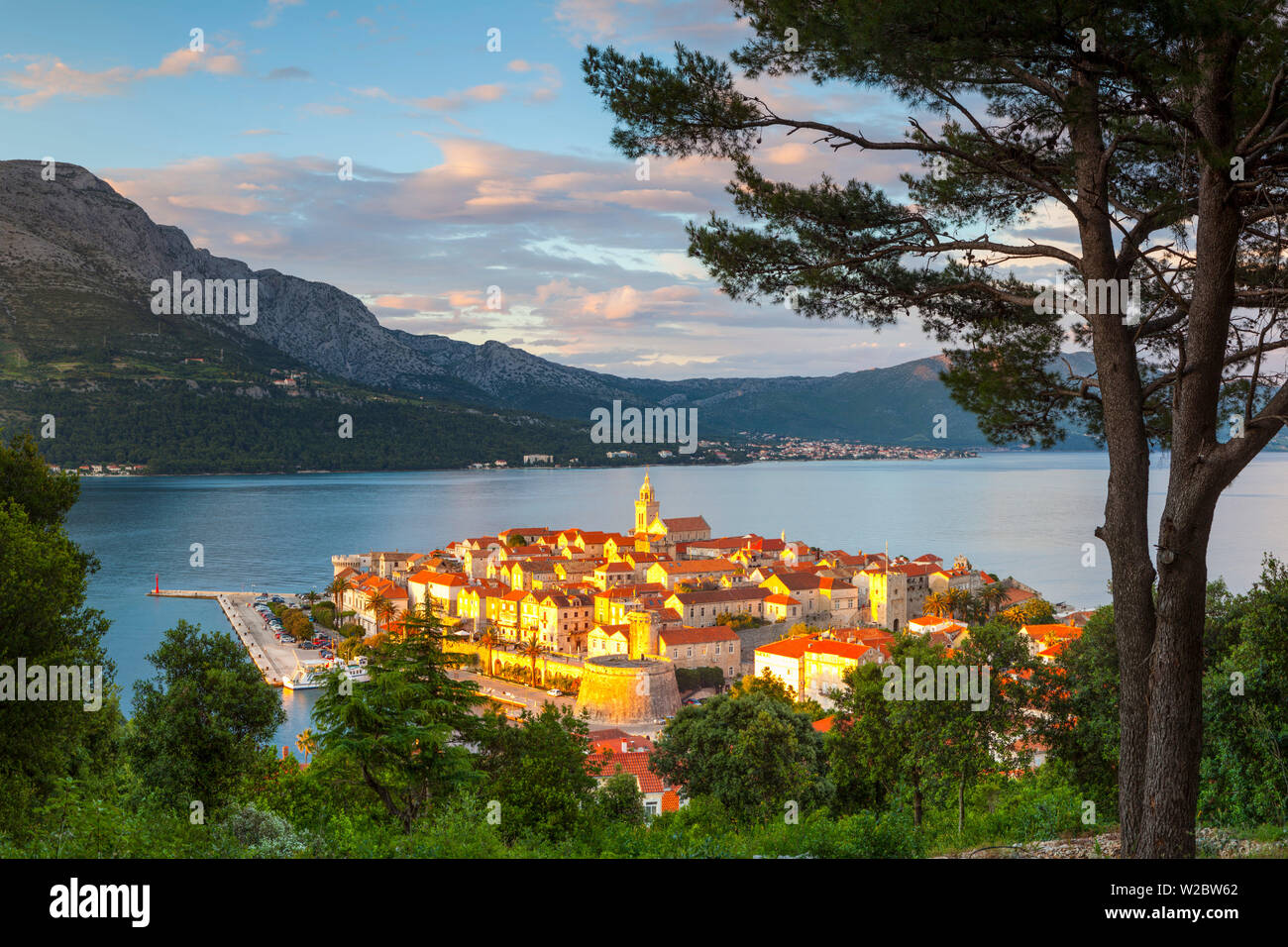 Erhöhte Blick über die malerische Stadt Korcula beleuchtet bei Sonnenuntergang, Korcula, Dalmatien, Kroatien Stockfoto