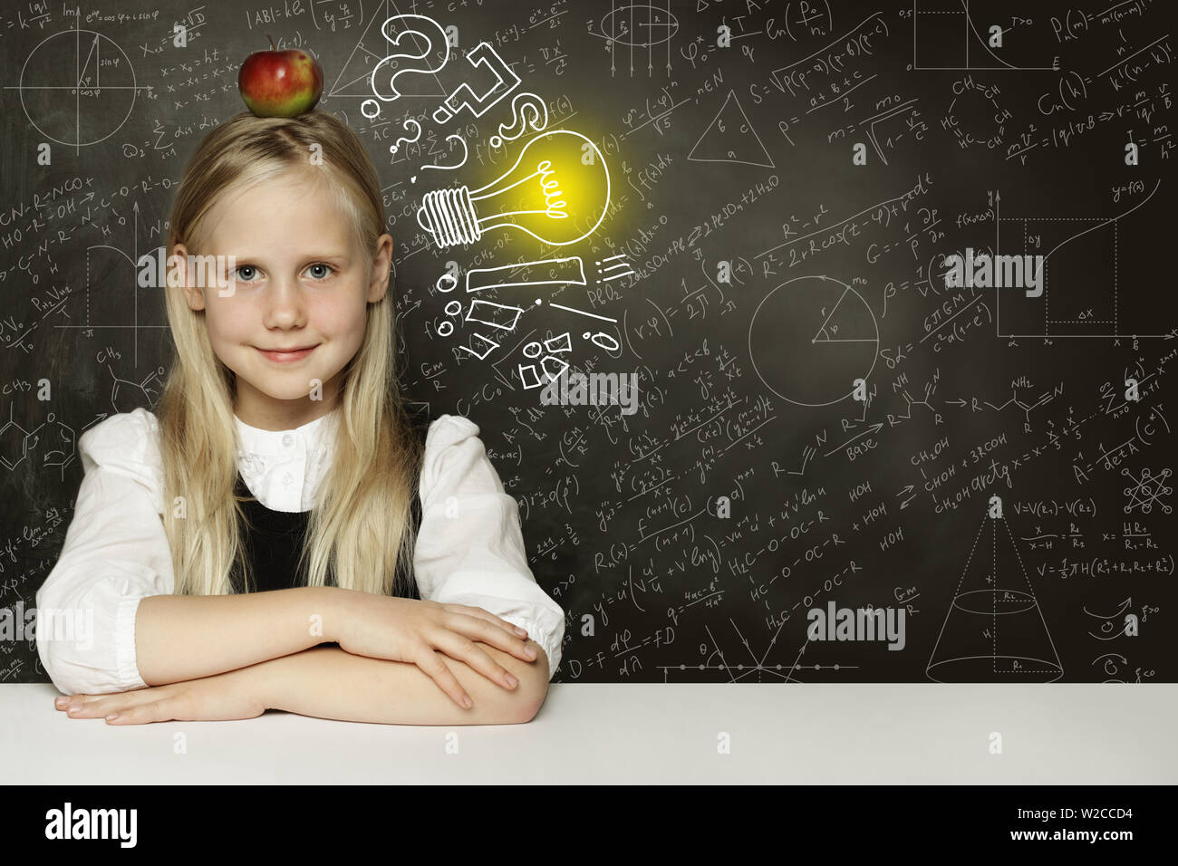 Idee! Smiling Student Mädchen mit Apfel und Glühbirne auf blackboard Stockfoto
