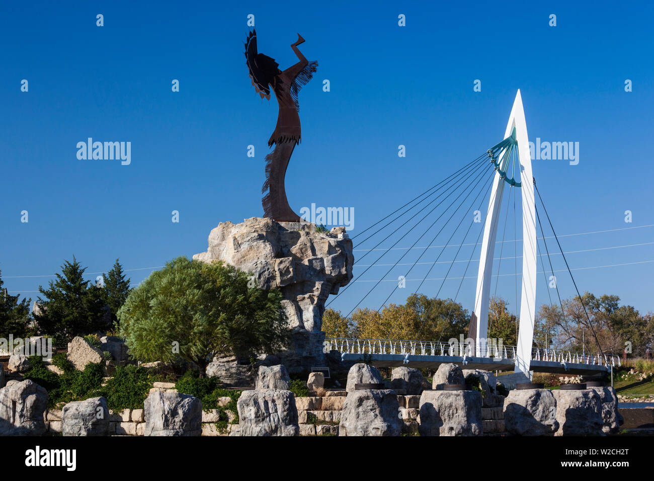 Hüter der Plains Statue und Fußgängerbrücke über den Arkansas River, Wichita, Kansas, USA Stockfoto
