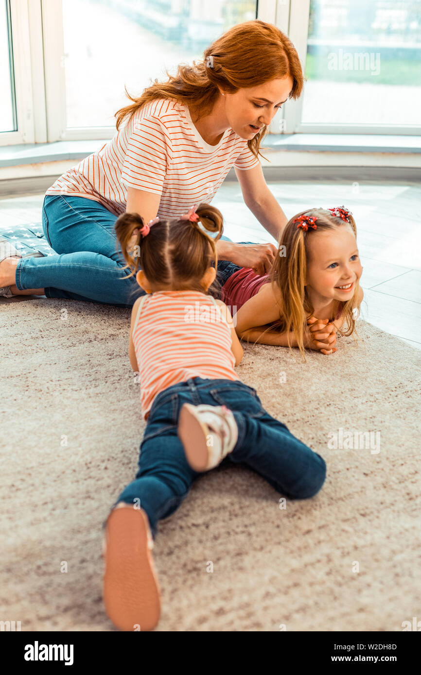 Schöne positive Mädchen spielen im Kindergarten Stockfoto