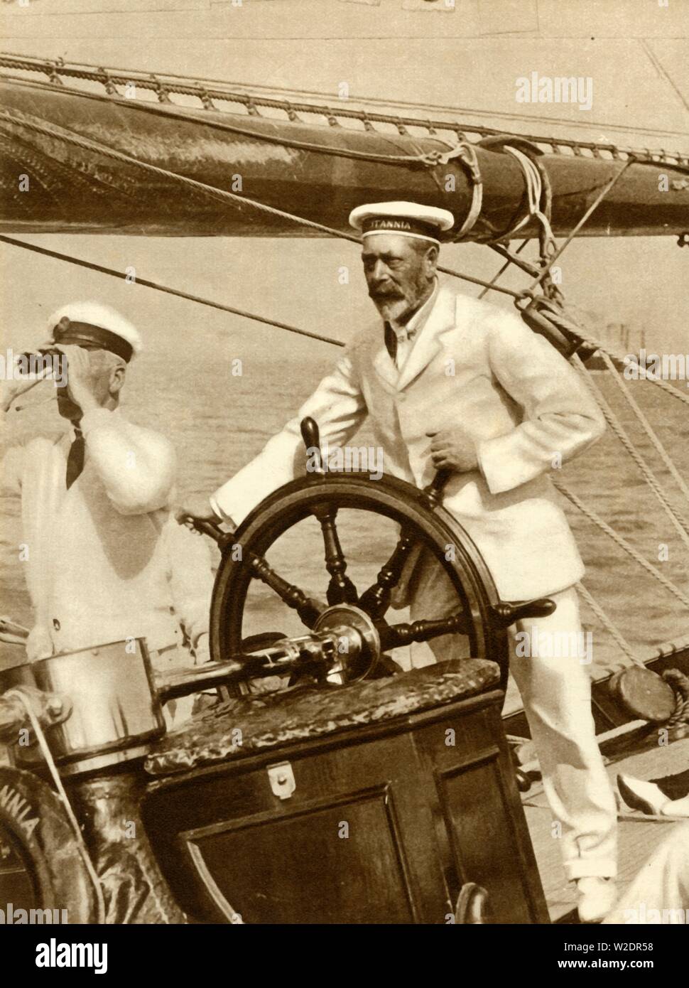 King George V am Rad von seiner Yacht, Britannia, während der Regatta in Cowes Week, 1924, (1935). Schöpfer: Unbekannt. Stockfoto