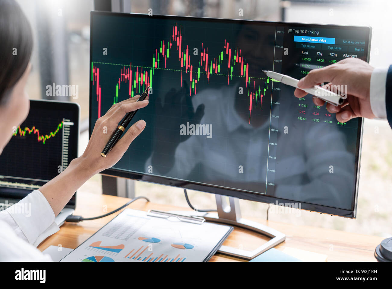 Team von Börsenmaklern diskutiert mit Anzeigen, die Analyse von Daten, Diagramme und Berichte Börsenhandel für Investitionen Stockfoto