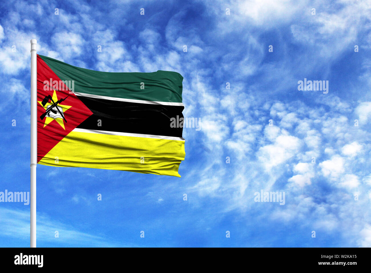 Nationalflagge von Mosambik auf einem Fahnenmast vor blauem Himmel Stockfoto