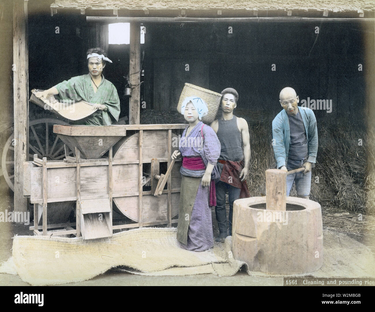 [1880s Japan - Japanische Bauern Worfeln Reis] - Japanische Landwirte sind worfeln Reis mit einem toumi (worfeln Maschine), Ca. In den 1880ern. Der Prozess der Trennung der Körner von der Spreu wurde als "fusen", und bezog eine Person die Fütterung der toumi mit Getreide, während ein anderer der Lüfter gedreht. Der Wind tat sein Übriges. Die Maschine könnte eingestellt werden Wirksamkeit zu erhöhen. 19 Vintage albumen Foto. Stockfoto