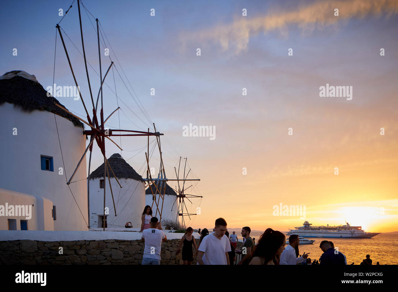 Mykonos, ˈMikonos griechische Insel, Teil der Kykladen, Griechenland. Wahrzeichen solo Windmühle im Hafen bei Sonnenuntergang Stockfoto