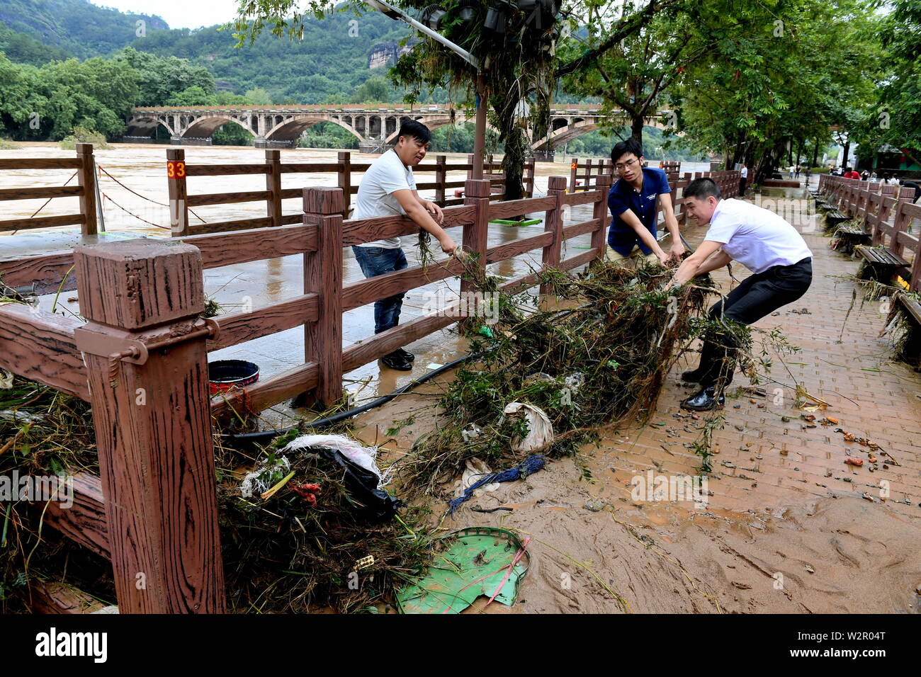 Wuyishan. 10. Juli 2019. Mitarbeiter clean up Abfälle am Mount Wuyi Scenic Area nach einem Hochwasser im Südosten der chinesischen Provinz Fujian, 10. Juli 2019. Schwere Regenfälle hit Wuyishan City am Dienstag verursacht Anstieg von Wasser, malerische Orte und unterbrochenen Stromversorgung und Kommunikation beschädigt. Credit: Zhang Guojun/Xinhua/Alamy leben Nachrichten Stockfoto