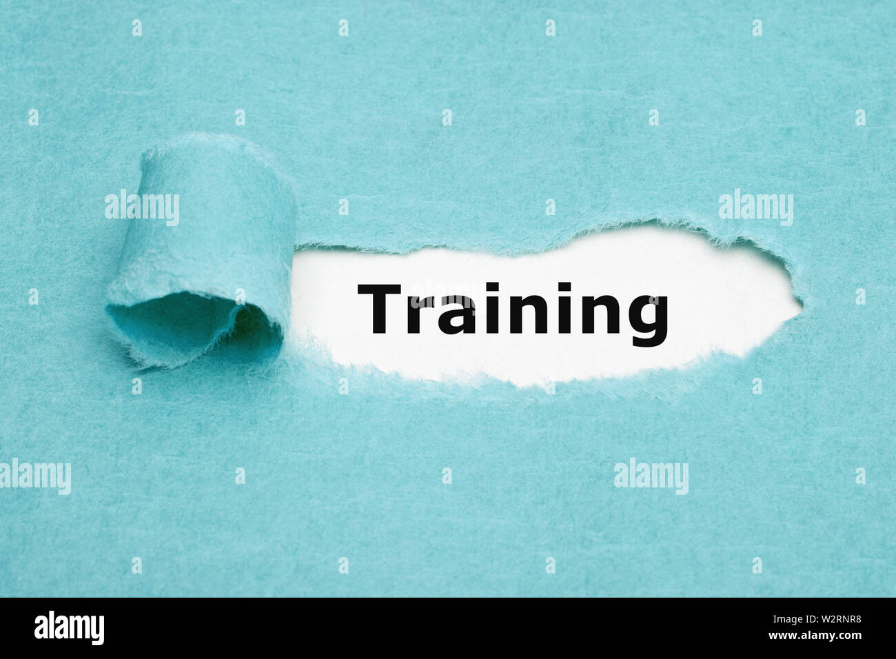 Gedruckte Wort Training erscheinen hinter zerrissen blaues Papier. Konzept über das Lernen und Üben neue Fähigkeiten für einen bestimmten Job. Stockfoto