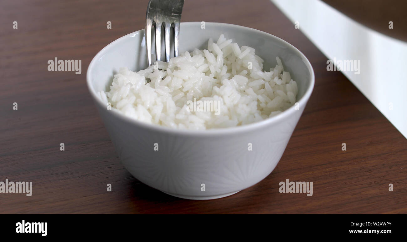 Nahaufnahme von Frau Reis essen aus dem Abscheidegefäß Stockfoto