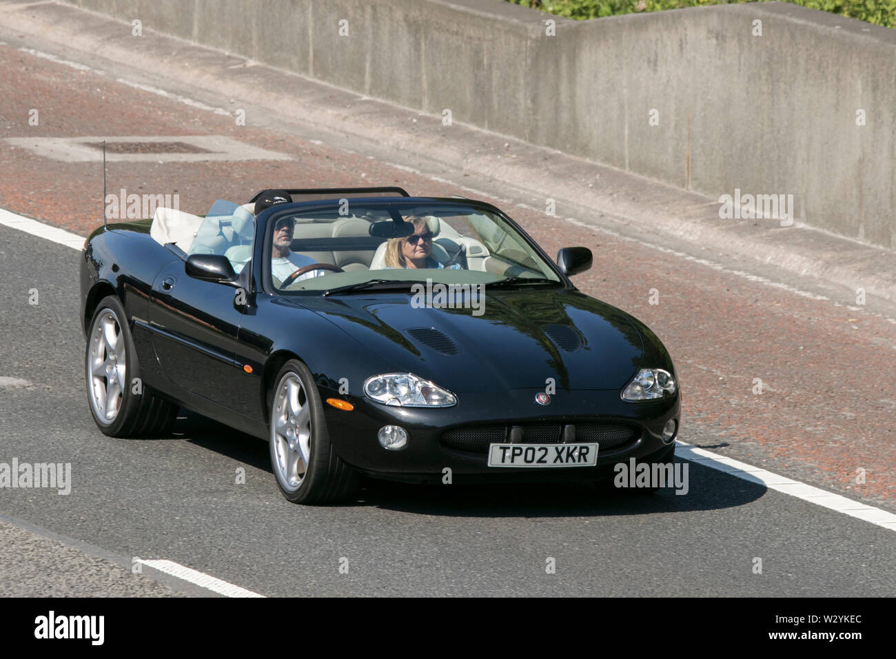 2002, Jaguar XKR Auto; Vintage classic restaurierte Fahrzeuge Autos auf der Autobahn M6 an der Leighton Hall Car Show in Carnforth, Lancaster, Großbritannien reisen Stockfoto