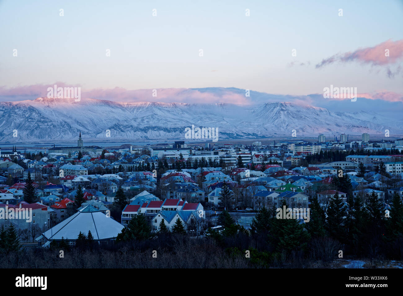 Wide Angle 120° Sonnenuntergang Panorama von Osten die Stadt Reykjavik im Winter mit schneebedeckten Bergen im Hintergrund von der Oberseite der perlan Turm (Bild 5/7) Stockfoto