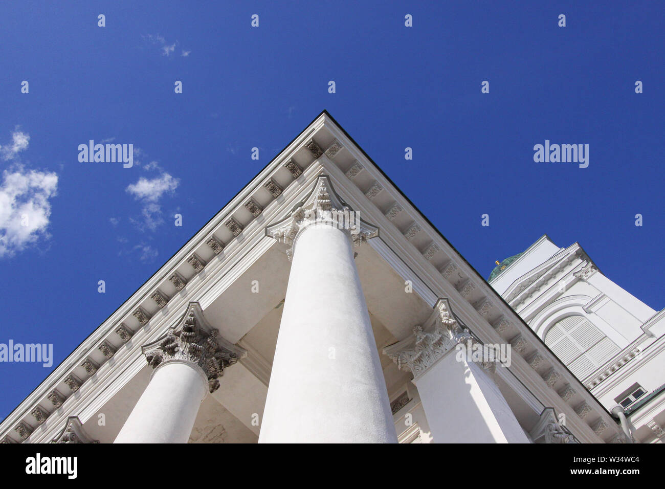 Spalten auf der Außenseite der Kathedrale von Helsinki mit Wolken im Hintergrund | Kathedrale von Helsinki ist ein Wahrzeichen, mit seinen hohen, grünen Kuppel s Stockfoto