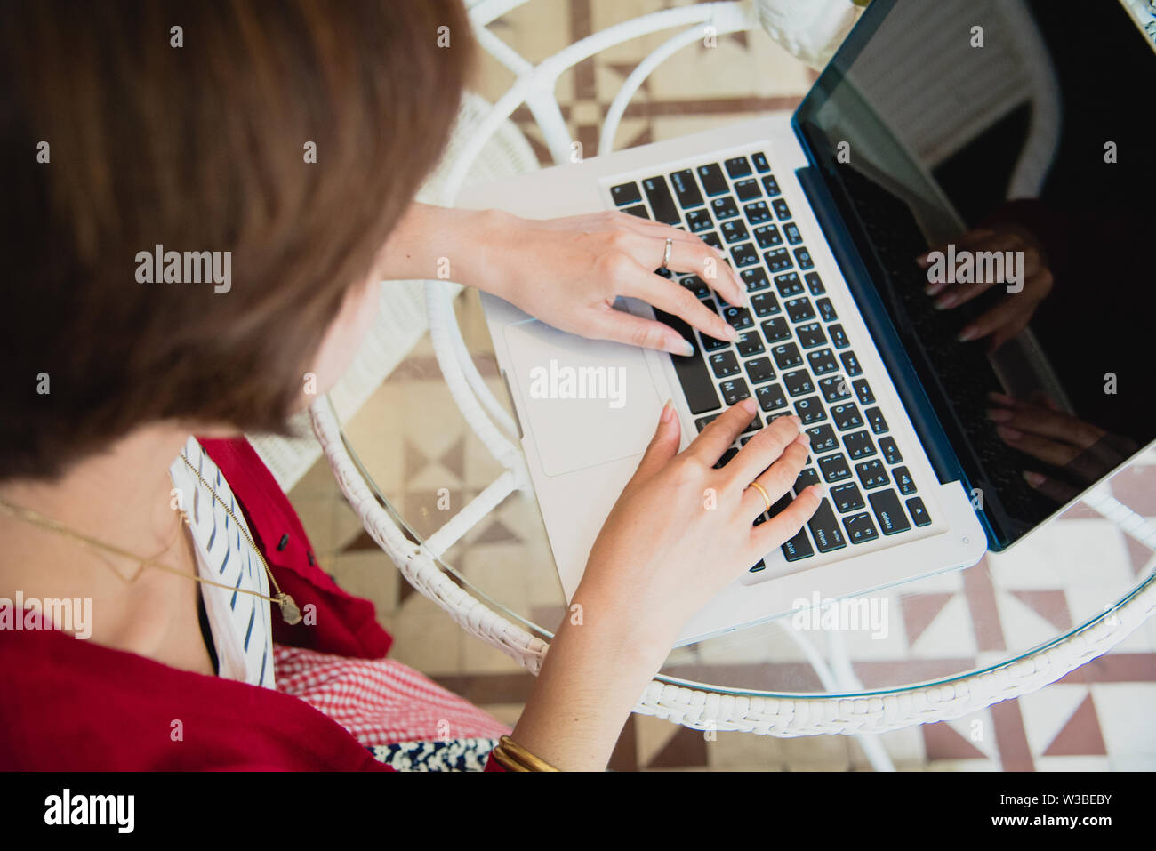 Chinesische Geschäftsfrau Arbeiten an Tablet Computer außerhalb der. Schöne Frau tragen rote T-Shirt Arbeiten im Freien. Stockfoto