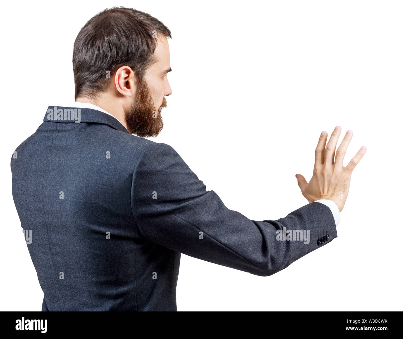 Geschäftsmann in Anzug zeigt ausgestreckte Hand withspread Finger. Über Hintergrund. Ansicht von hinten. Stockfoto