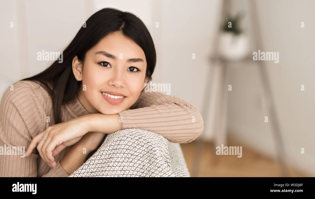 Portrait von asiatischen Mädchen ruht auf einem Sofa im Wohnzimmer. Stockfoto