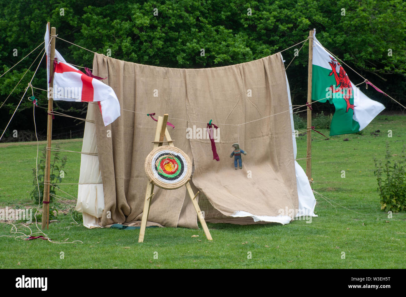 Mittelalterliche Bogenschießen Target Board im Feld mit Flagge von Wales und George Cross Stockfoto